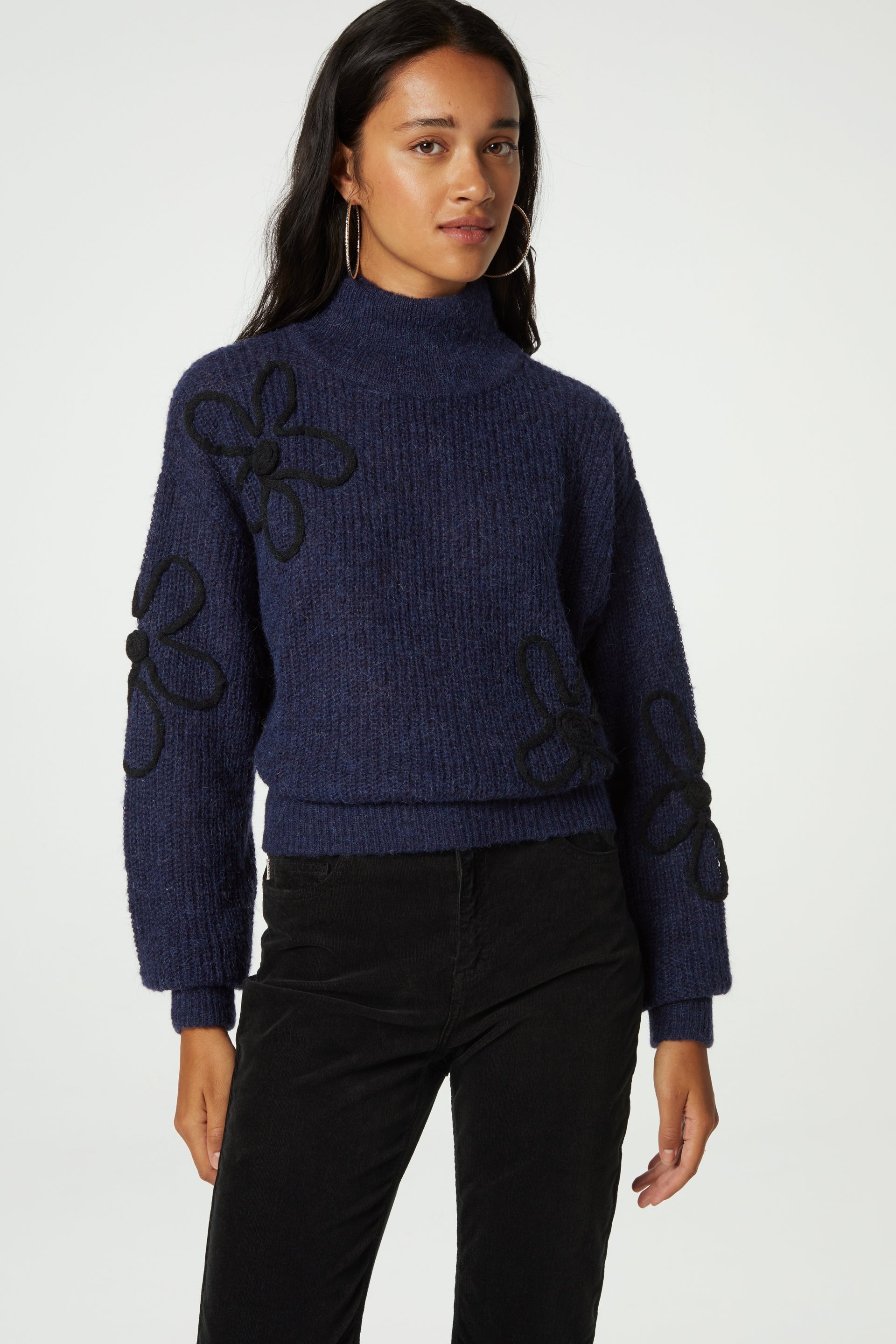 Navy turtleneck jumper with black knitted floral details