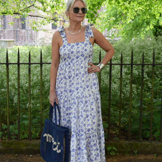 Strappy summer dress with ecru background and blue sea shelll and crab print with tiered skirt