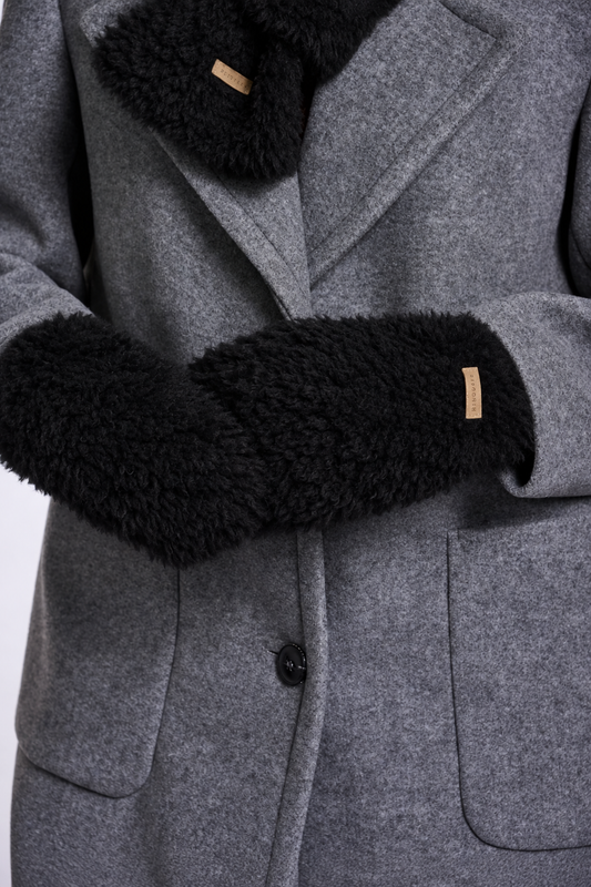 Close-up of a gray wool coat with black faux-fur trim on the collar and cuffs, featuring a small tan brand tab.