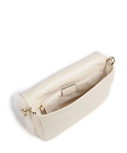 Soft beige shearling handbag with long strap.