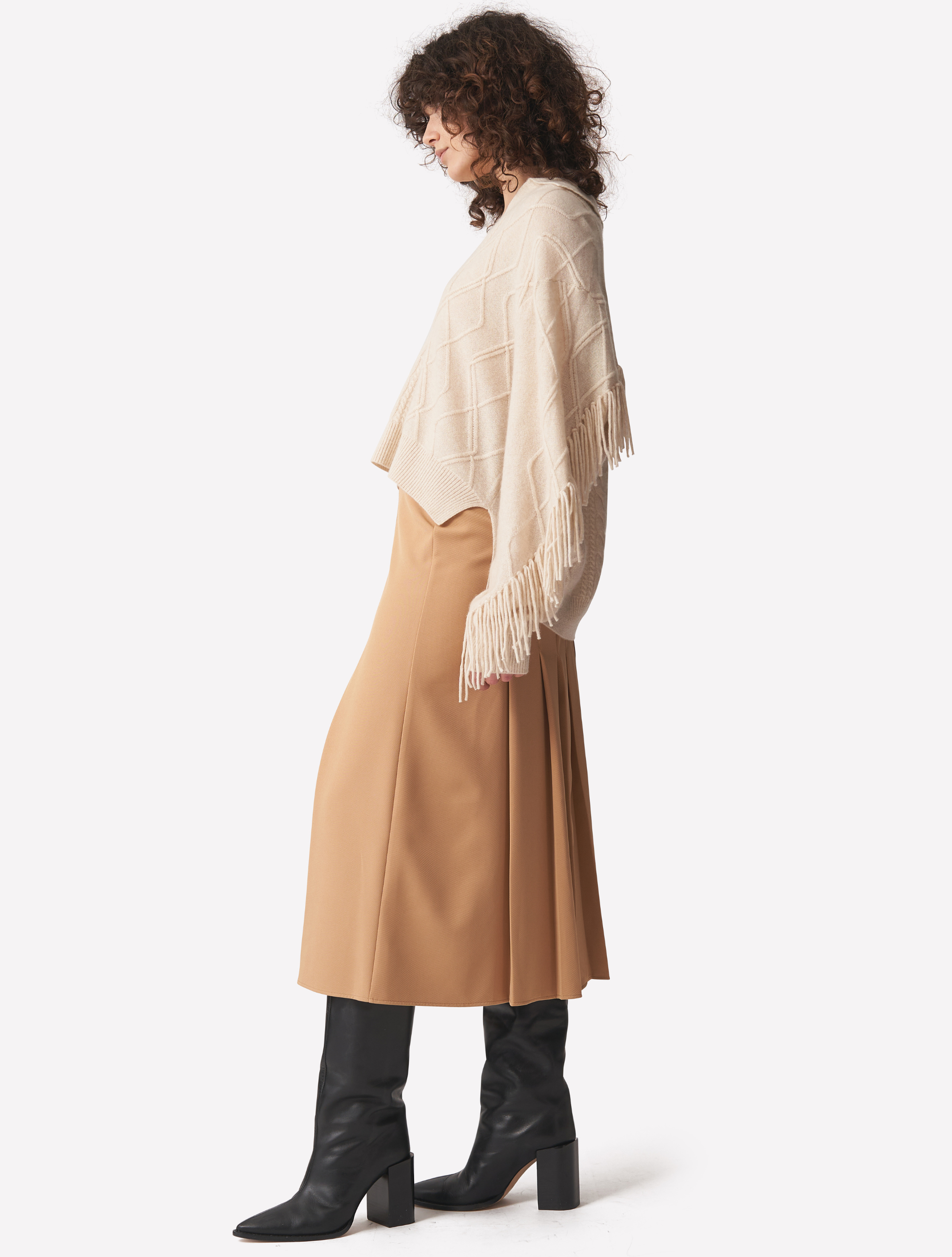 Ecru cashmere polo neck jumper with dropped shoulders cable knit and fringing details across arms and back