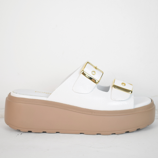 White platform slider with double strap gold metallic buckles and taupe coloured rubber platform sole