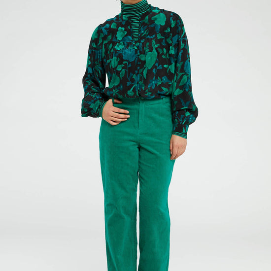 Straight cut vibrant green jumbo cord trousers with a turn up at the hem