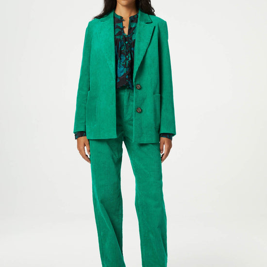 Straight cut vibrant green jumbo cord trousers with a turn up at the hem