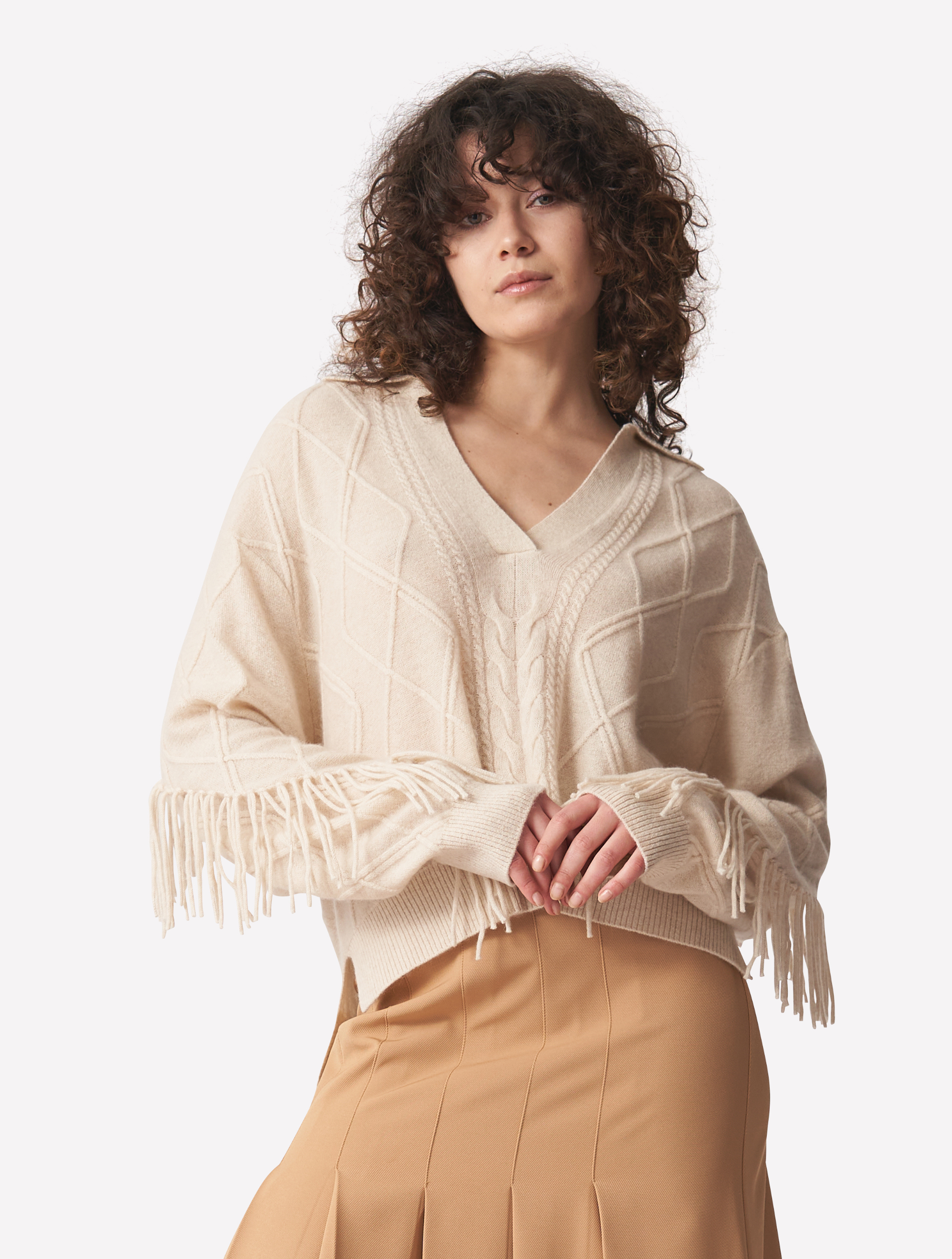 Ecru cashmere polo neck jumper with dropped shoulders cable knit and fringing details across arms and back