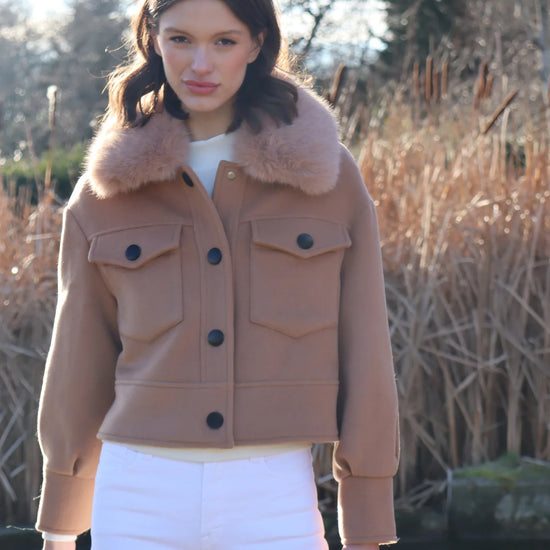 cropped tan wool jacket with covered buttons and 2 front flap pockets model shot