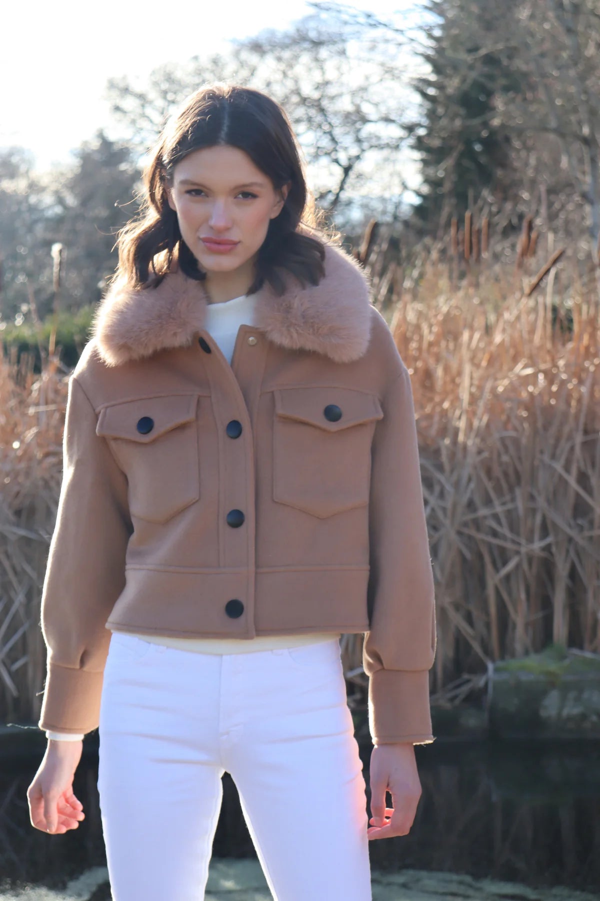 cropped tan wool jacket with covered buttons and 2 front flap pockets model shot