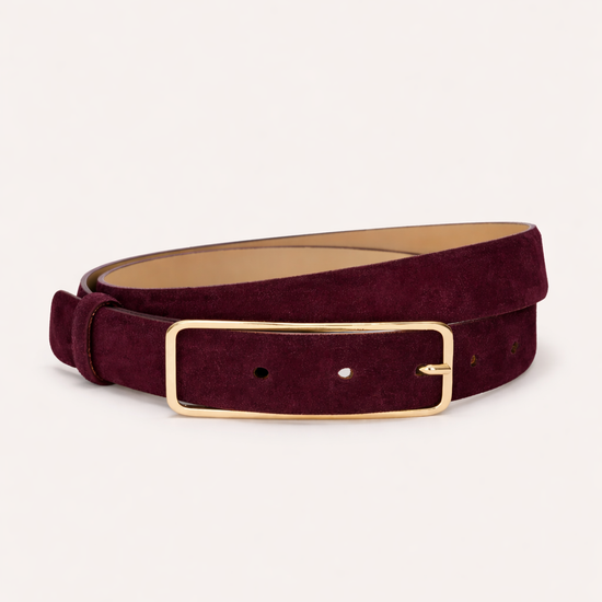 suede belt in a wine colour as a flat lay on a white background