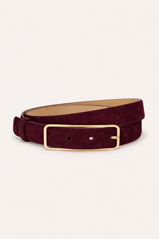 suede belt in a wine colour as a flat lay on a white background