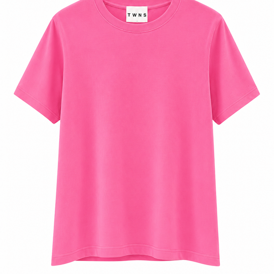 A bright pink short-sleeve crewneck t-shirt with a white neck label reading 'T WNS', displayed against a solid white background.