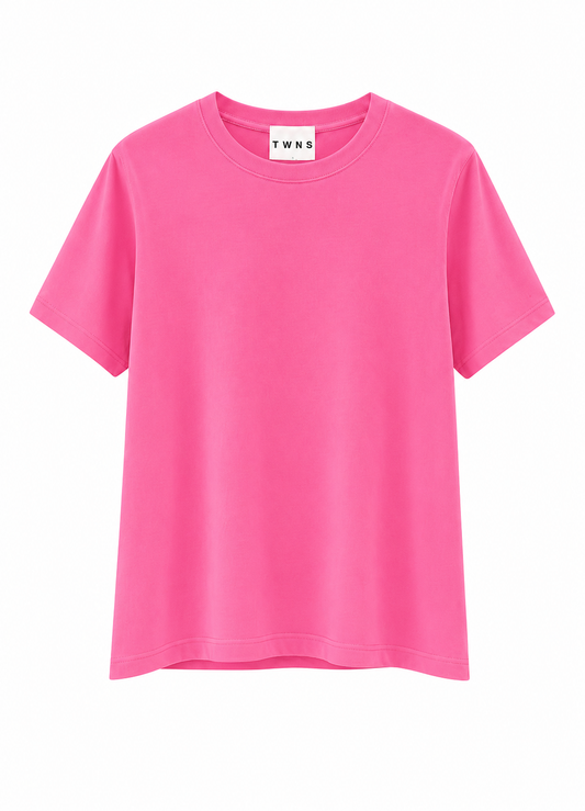 A bright pink short-sleeve crewneck t-shirt with a white neck label reading 'T WNS', displayed against a solid white background.