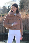 cropped tan wool jacket with covered buttons and 2 front flap pockets model shot