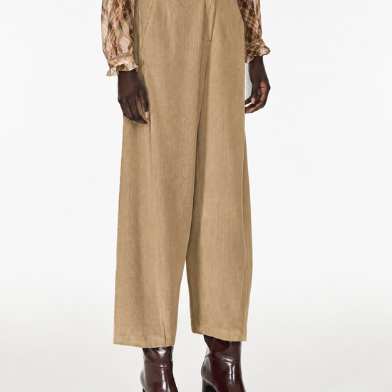 model wearing cord barrel trousers 