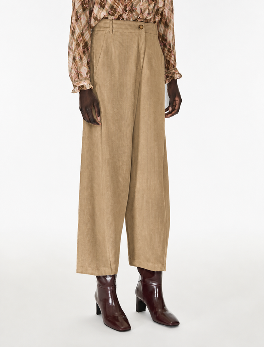model wearing cord barrel trousers 