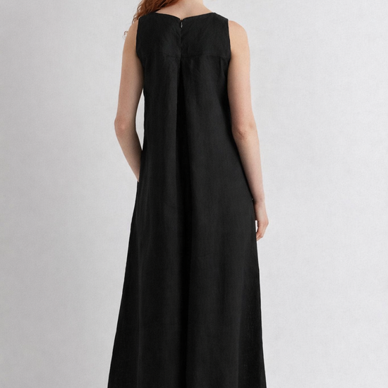 Woman wearing a black sleeveless dress on a white background