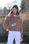 cropped tan wool jacket with covered buttons and 2 front flap pockets model shot