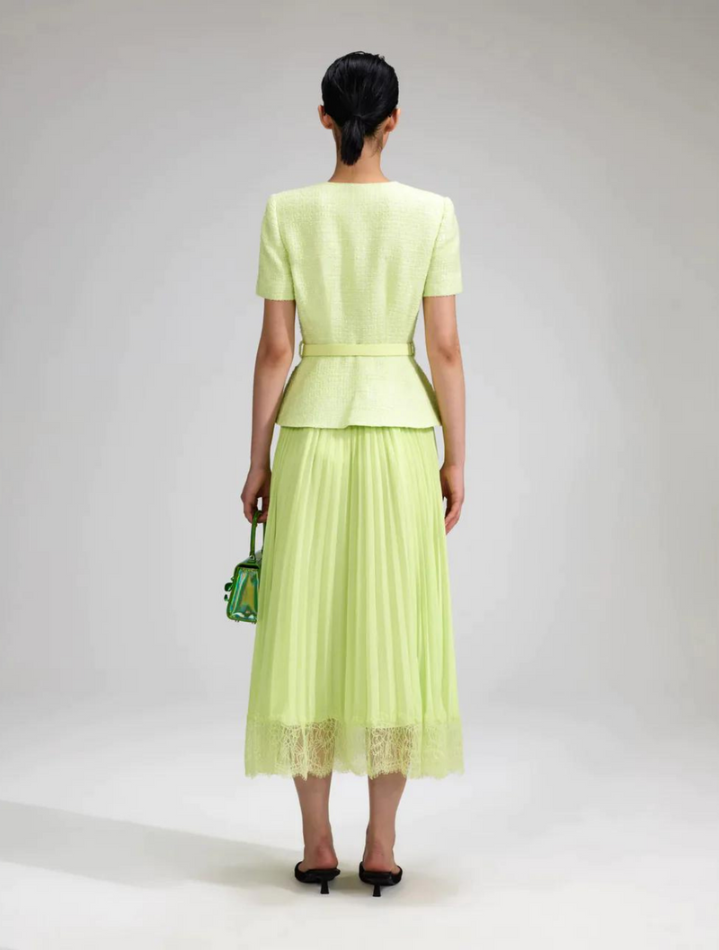 Lime green dress with short sleeved jacket style bodice featuring four flap pockets and a pleated midi skirt with lace hem and fully lined