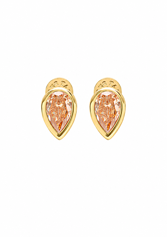 A pair of gold teardrop-shaped stud earrings with pear-cut peach-colored gemstones, set against a plain white background.