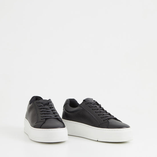 Black leather trainers with white chunky platform sole and heel