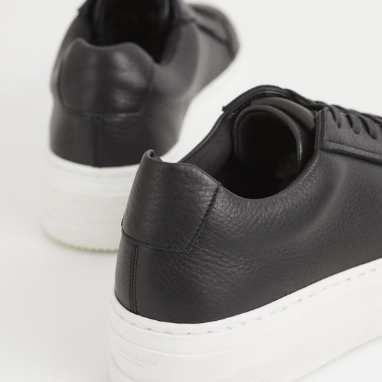 Black leather trainers with white chunky platform sole and heel