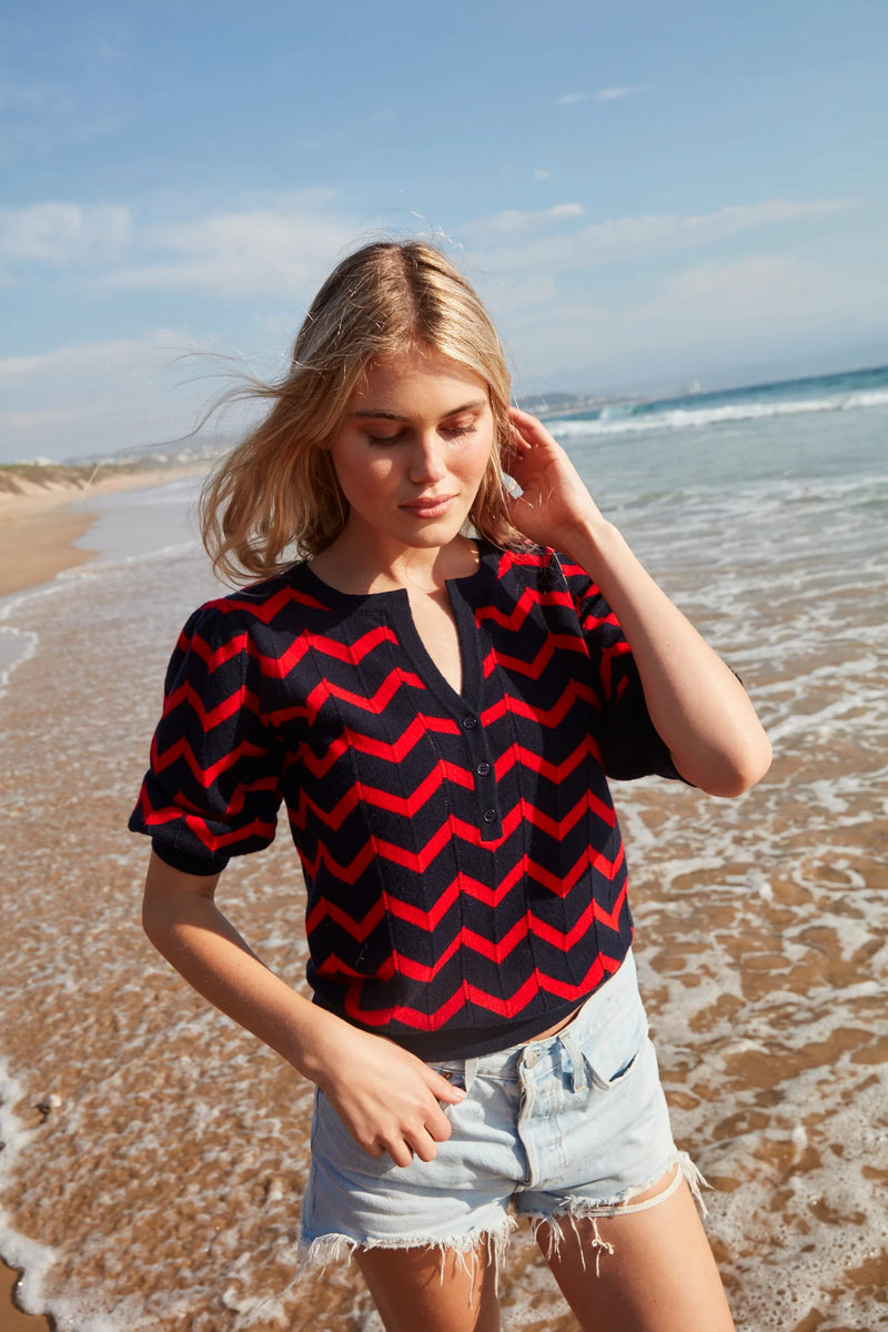 Navy and red chevron short sleeved top with notch neckline and ribbed cuffs and hem