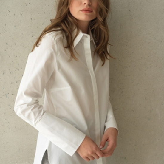 White button up shirt with a curved hem and wide collar, with three buttons  at the neck. 