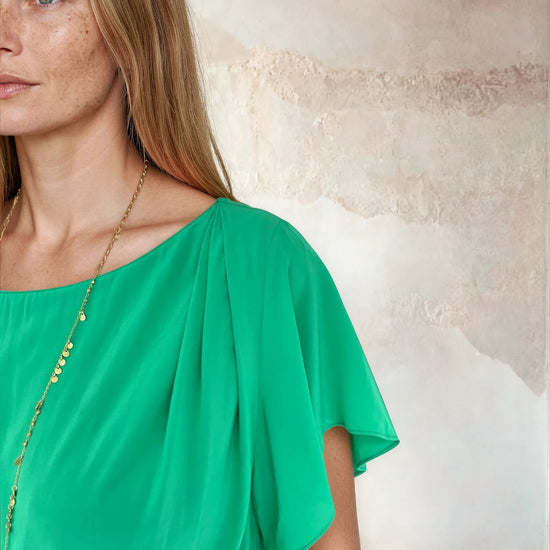 Close up of sleeve on flutter top green