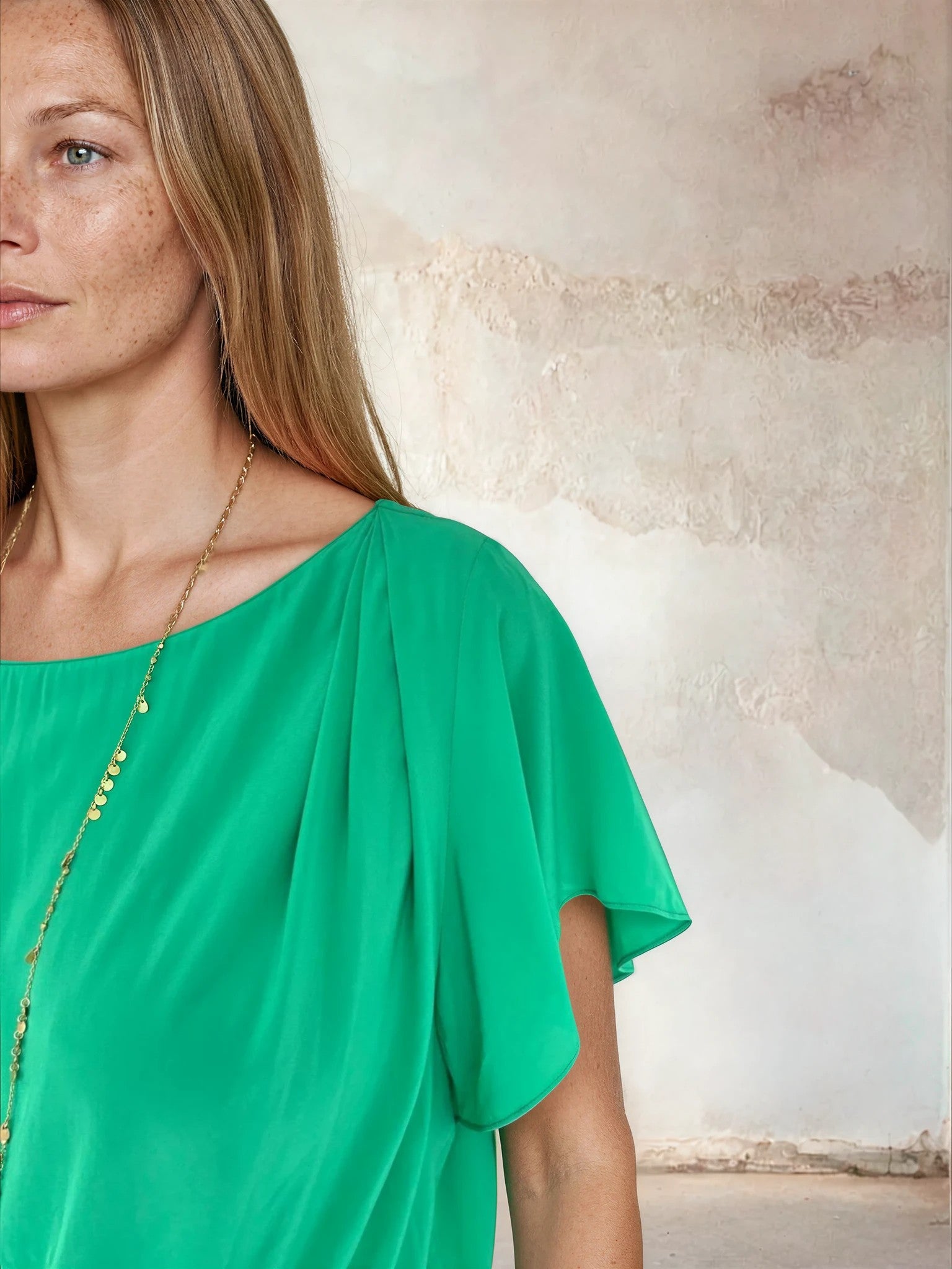 Close up of sleeve on flutter top green