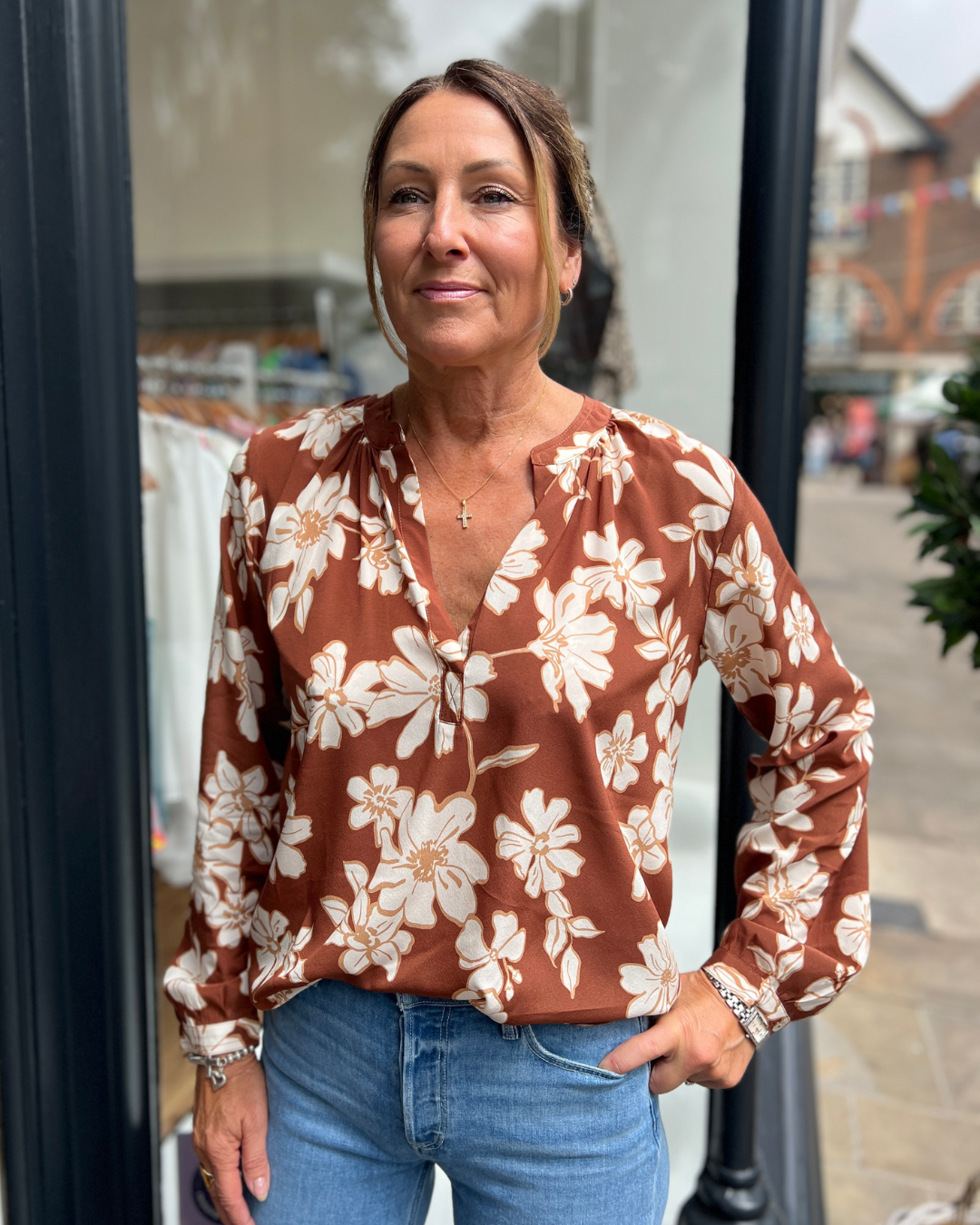 A tan top with white flowers 