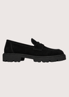 Black suede loafer with a black sole on a grey background