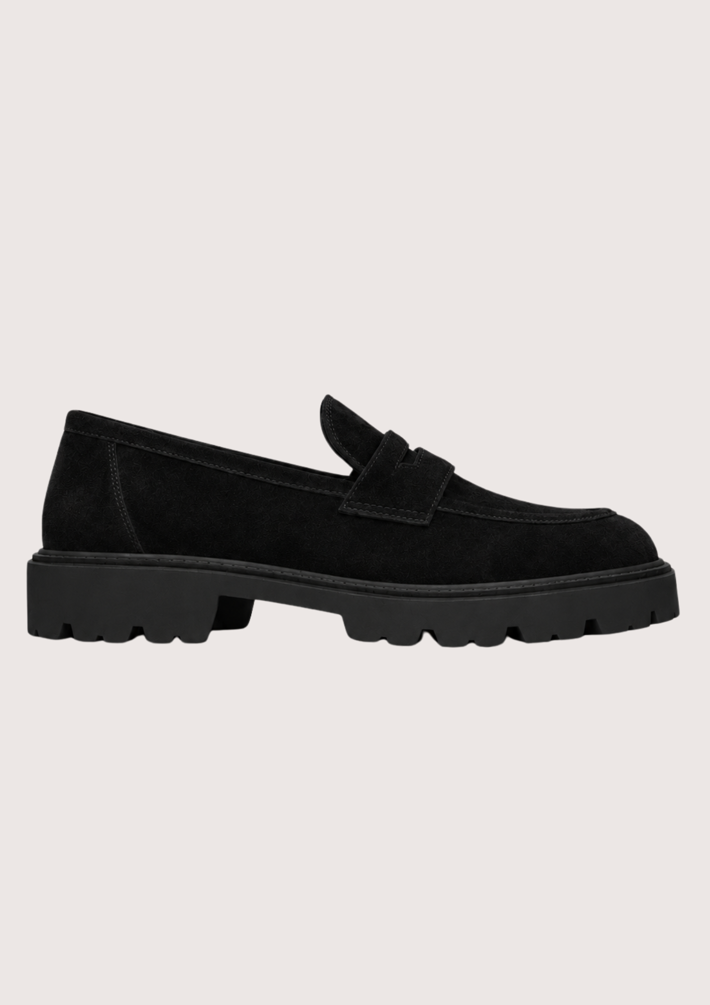 Black suede loafer with a black sole on a grey background