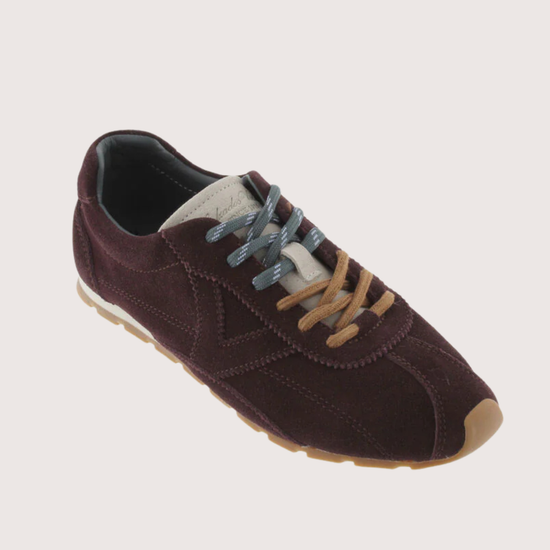 Brown suede sneaker with beige sole on a white background