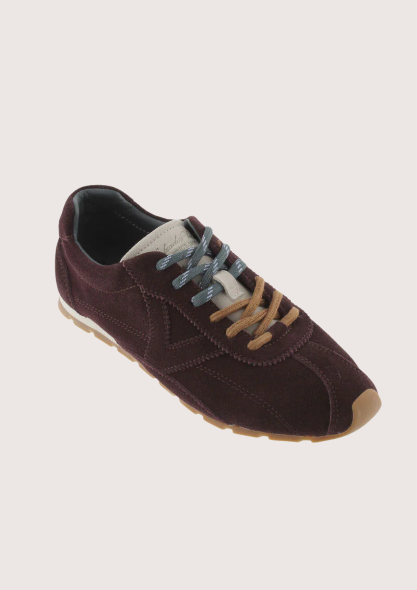 Brown suede sneaker with beige sole on a white background
