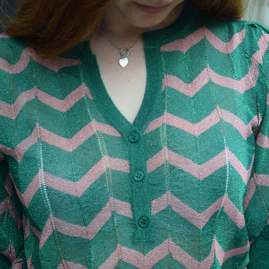 A green sparkly top with pink shevron zigzag