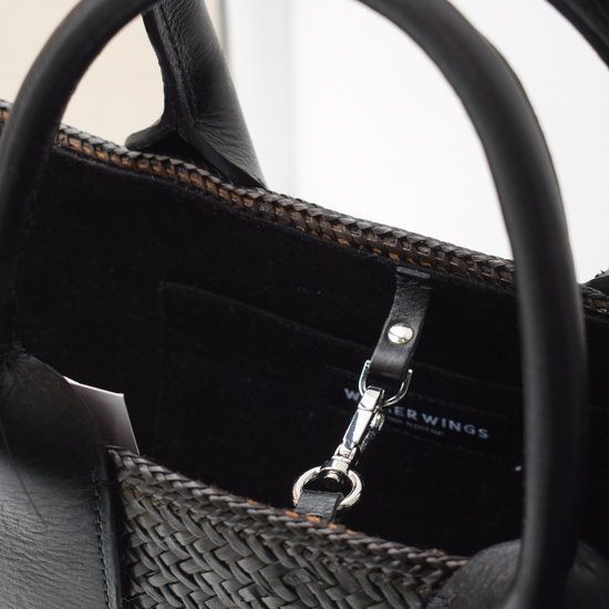 Hand woven black tote bag with leather handles