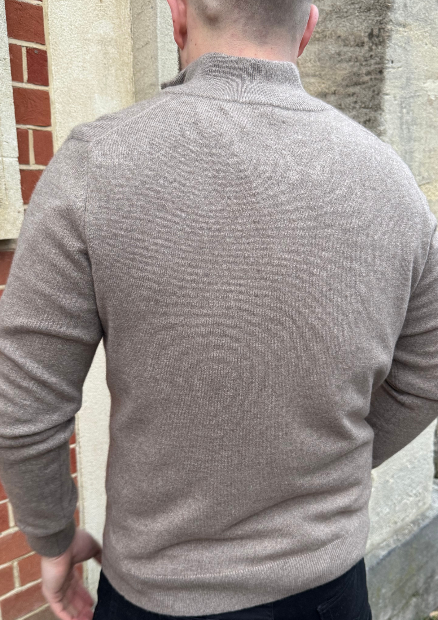 male model wearing brown cashmere quarter zip jumper.