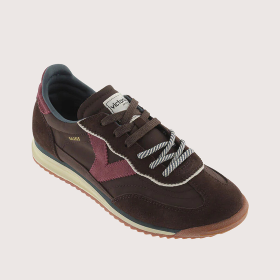 A dark brown suede and mesh sneaker with burgundy accents, featuring a cream midsole and a gum outsole, shown from a side profile on a light gray background.