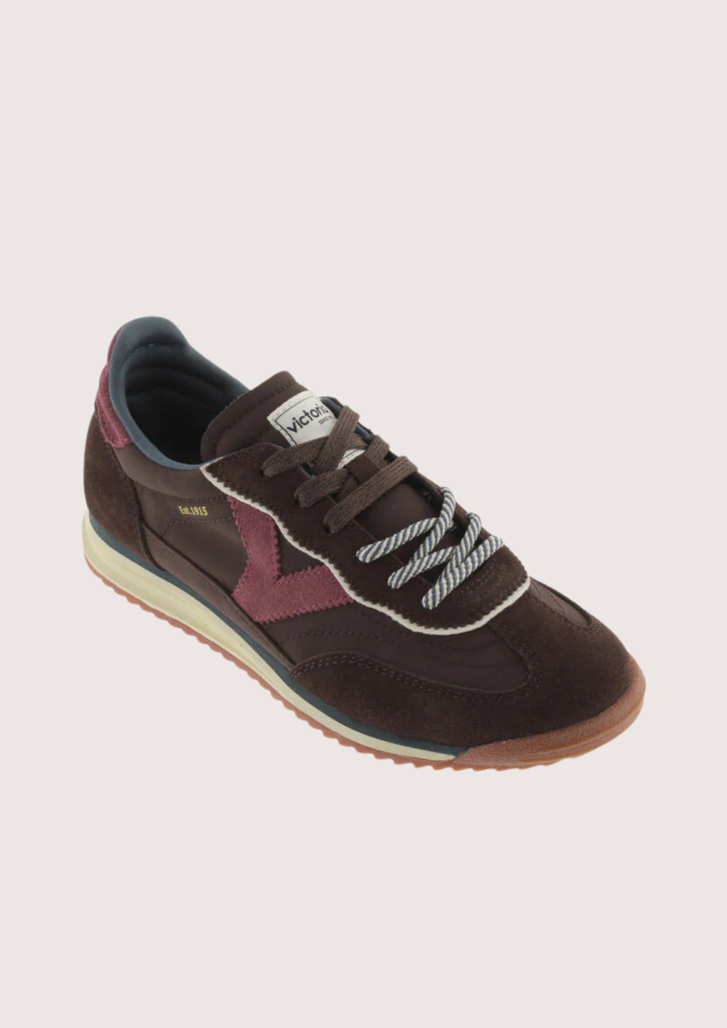 A dark brown suede and mesh sneaker with burgundy accents, featuring a cream midsole and a gum outsole, shown from a side profile on a light gray background.