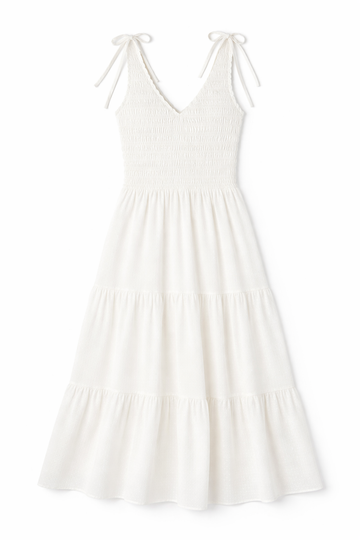 White tiered maxi dress with smocked bodice, ruffled V-neckline and shoulder ties in lightweight fabric.