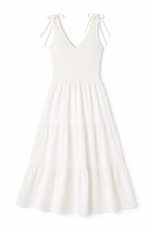 White tiered maxi dress with smocked bodice, ruffled V-neckline and shoulder ties in lightweight fabric.