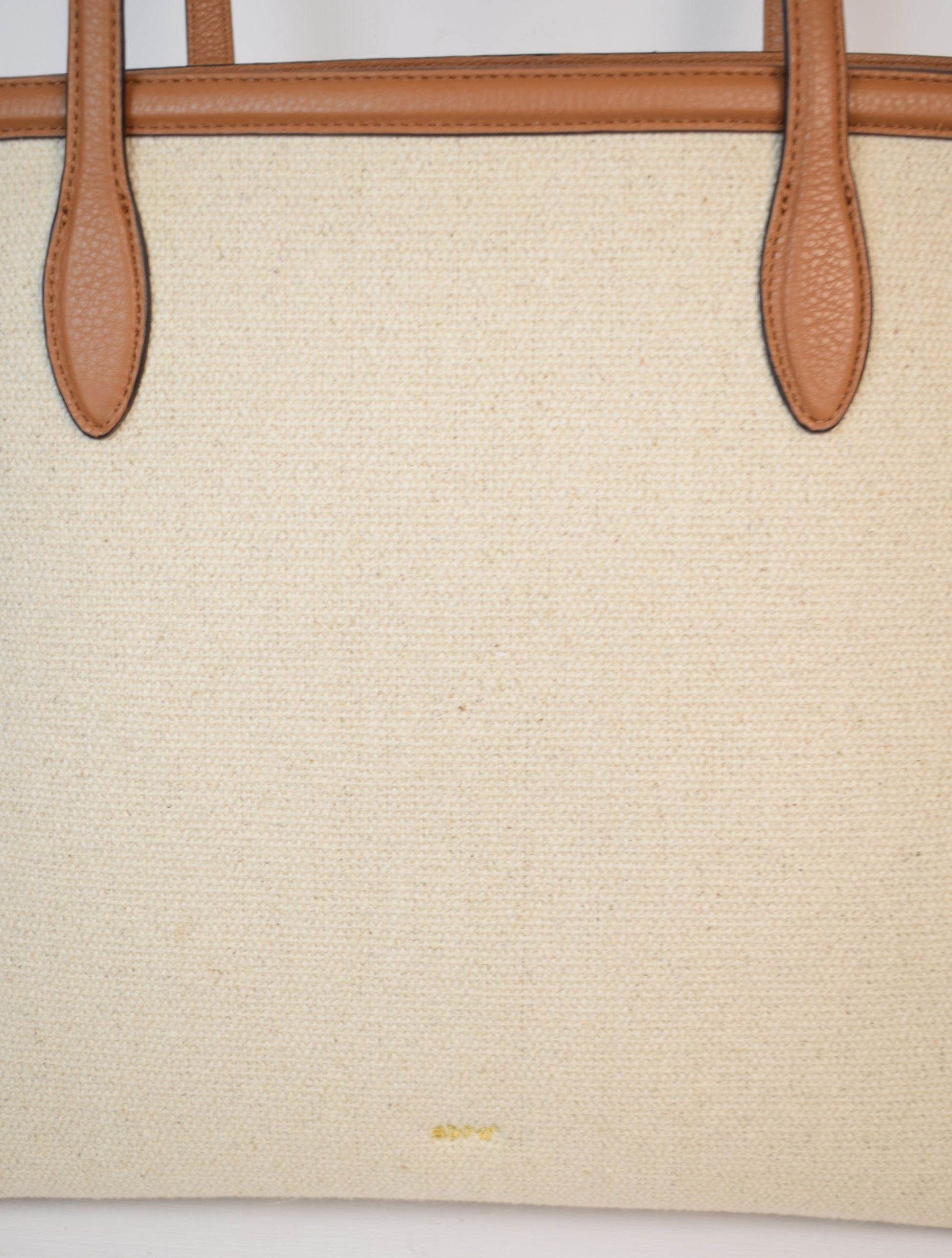 Neutral canvas totoe with tan leather trim