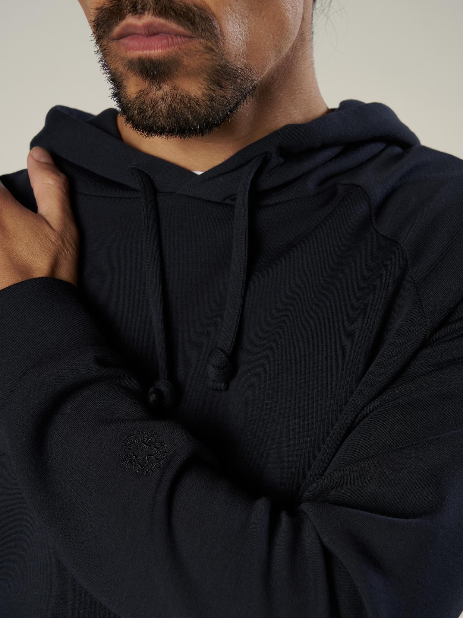 dark navy hooded sweatshirt with drawstring neck close up