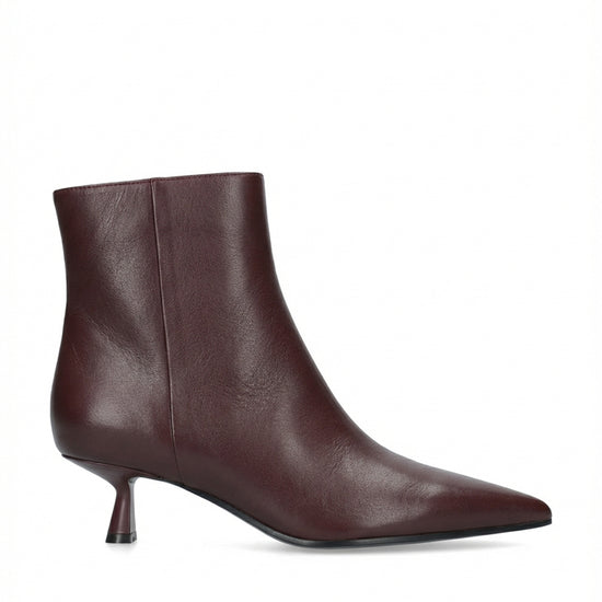 A single dark burgundy leather ankle boot with a pointed toe and a short kitten heel, shown from a side profile on a white background.