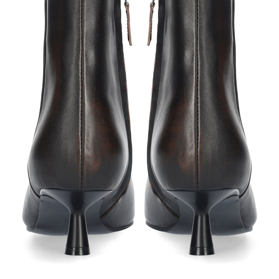 A pair of dark brown leather ankle boots with a pointed kitten heel, shown from the back on a white background.