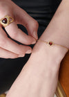 gold bracelet with spiky heart with red stone inside and lobster clasp from rachel jackson model shot