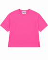 A bright pink short-sleeve crewneck t-shirt with side slits at the hem, displayed flat against a solid white background. The inner neck label shows the brand name 'TWN S'.