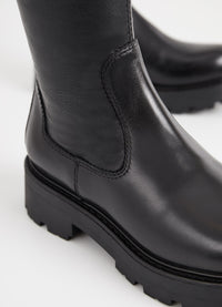 Long black leather boot with chunky sole and heel and inner zip fastening