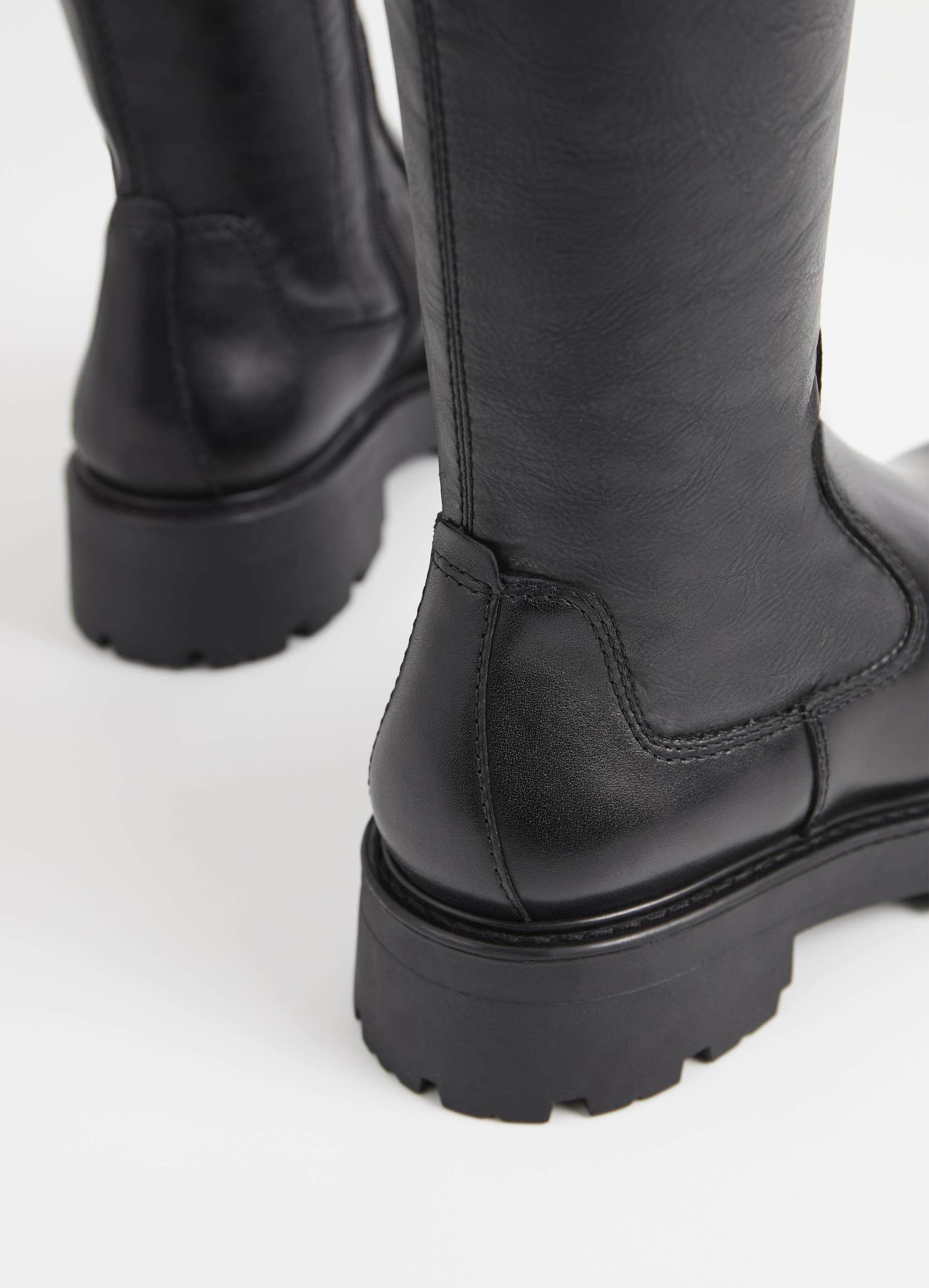 Long black leather boot with chunky sole and heel and inner zip fastening