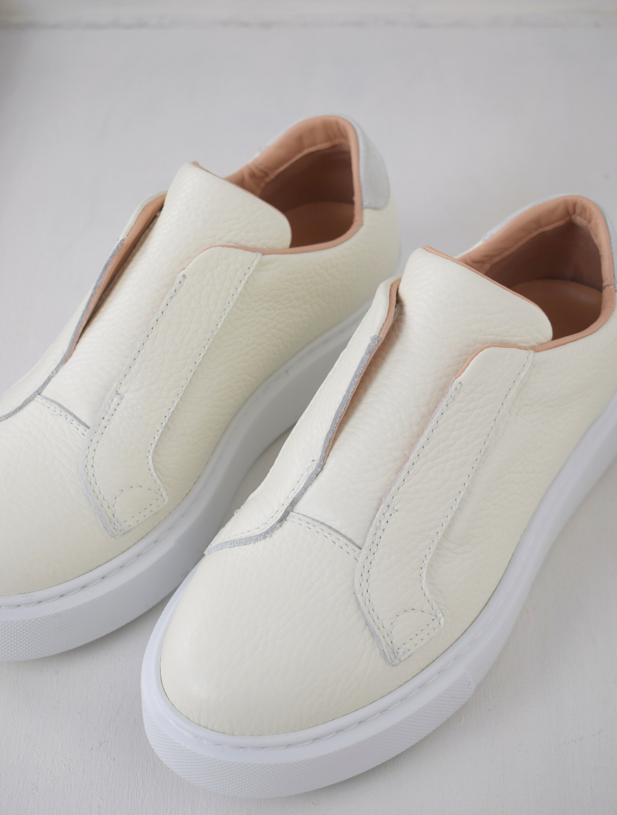 White platform trainers will elasticated side panels to make them easy to pull on