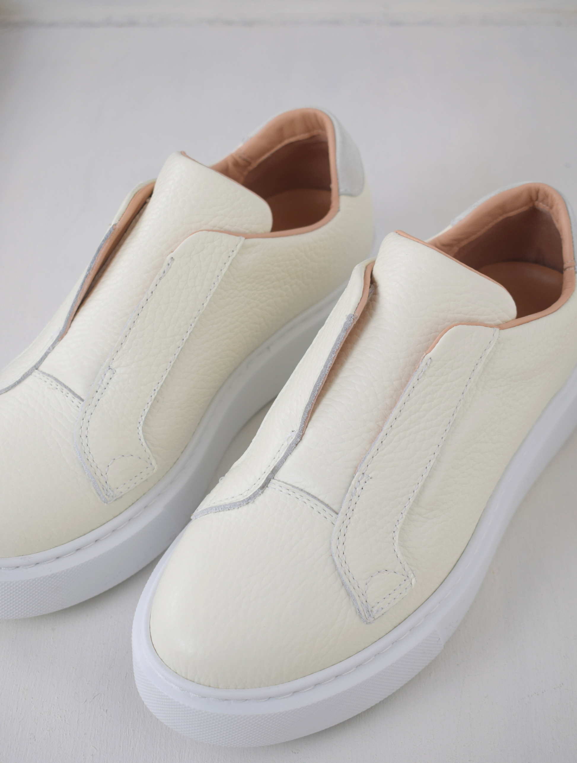 White platform trainers will elasticated side panels to make them easy to pull on